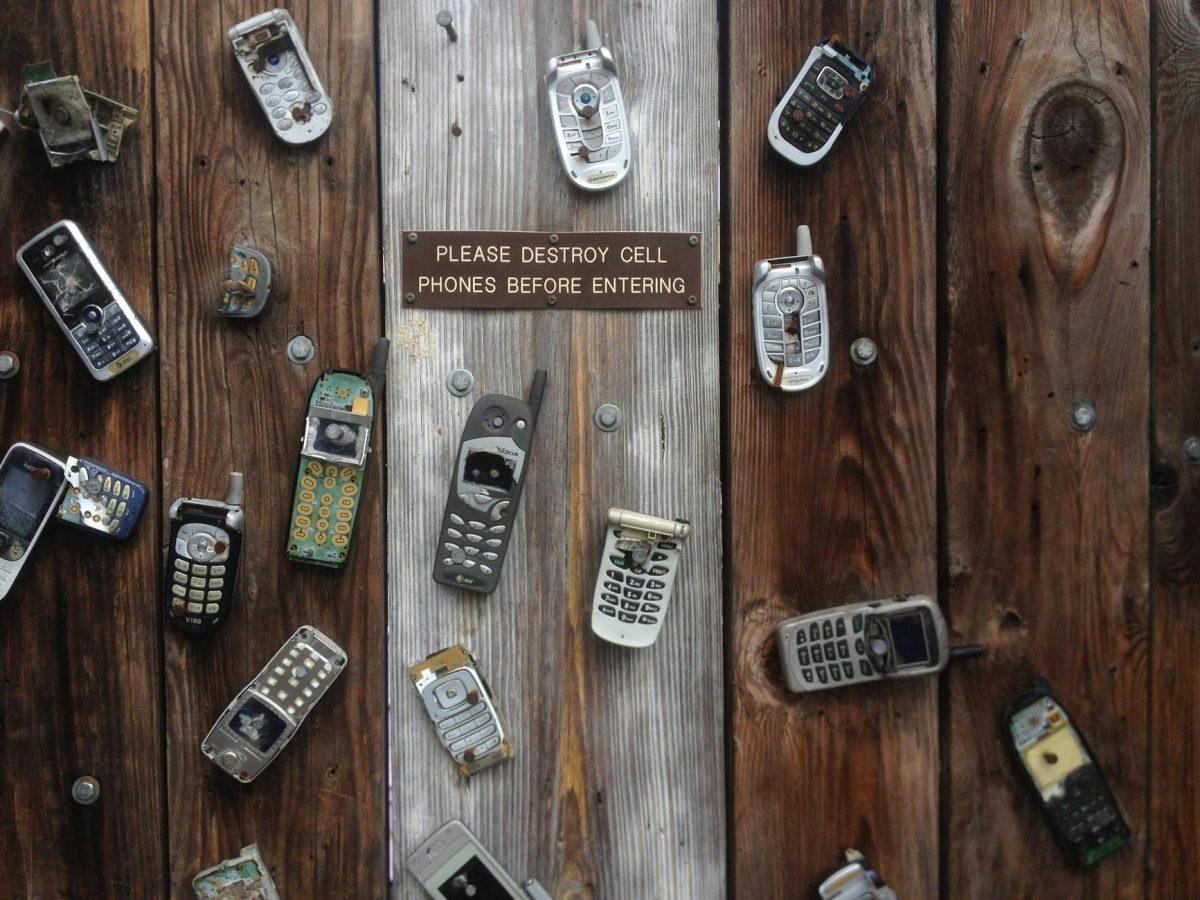 assorted phones on plank