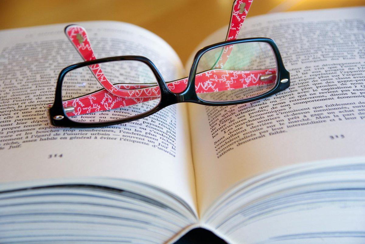 black framed eyeglasses on book page