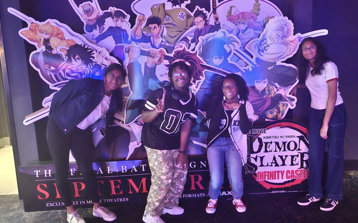 Nethra Thotakura ‘29, Loren McKee ‘29, Nyasha Ferrell ‘29 and Navya Thotakura ‘29 (pictured from left to right) have just watched the new Demon Slayer Infinity Castle Movie on Sept. 14, 2025 and are taking photos near their favorite characters with the display in the Atlantic Station Regal Theater. Photo Credit: Aravind Thotakura